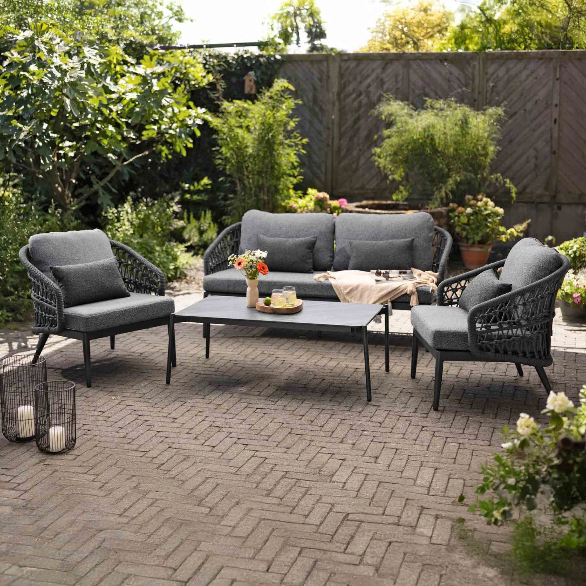 Garden view of Florence rope weave outdoor seating with center table for outdoor spaces